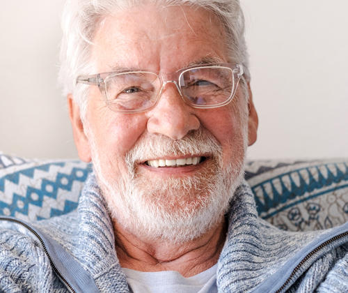 Older Geelong resident smiling with new dental implants.